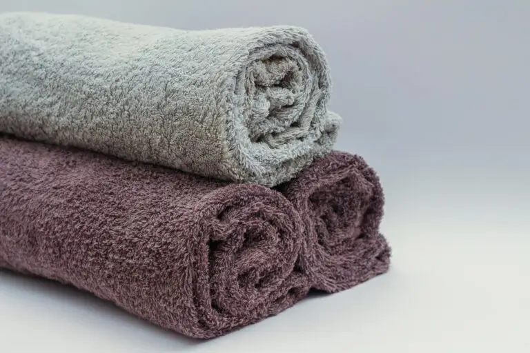 Close-up of rolled bathroom towels in neutral tones, ideal for interior design or spa themes.